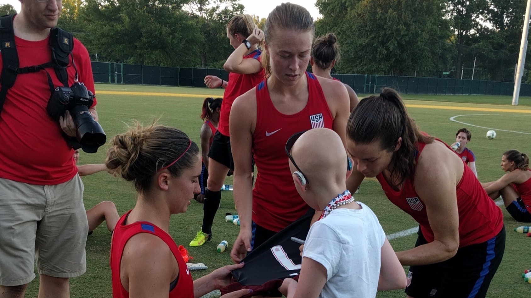 Kodi Tutt collects autographs from the U.S. Women's National Team